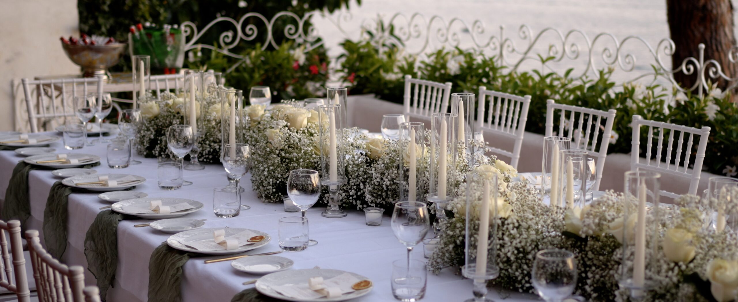 Wedding dinner table set with flowers, candles and glassware