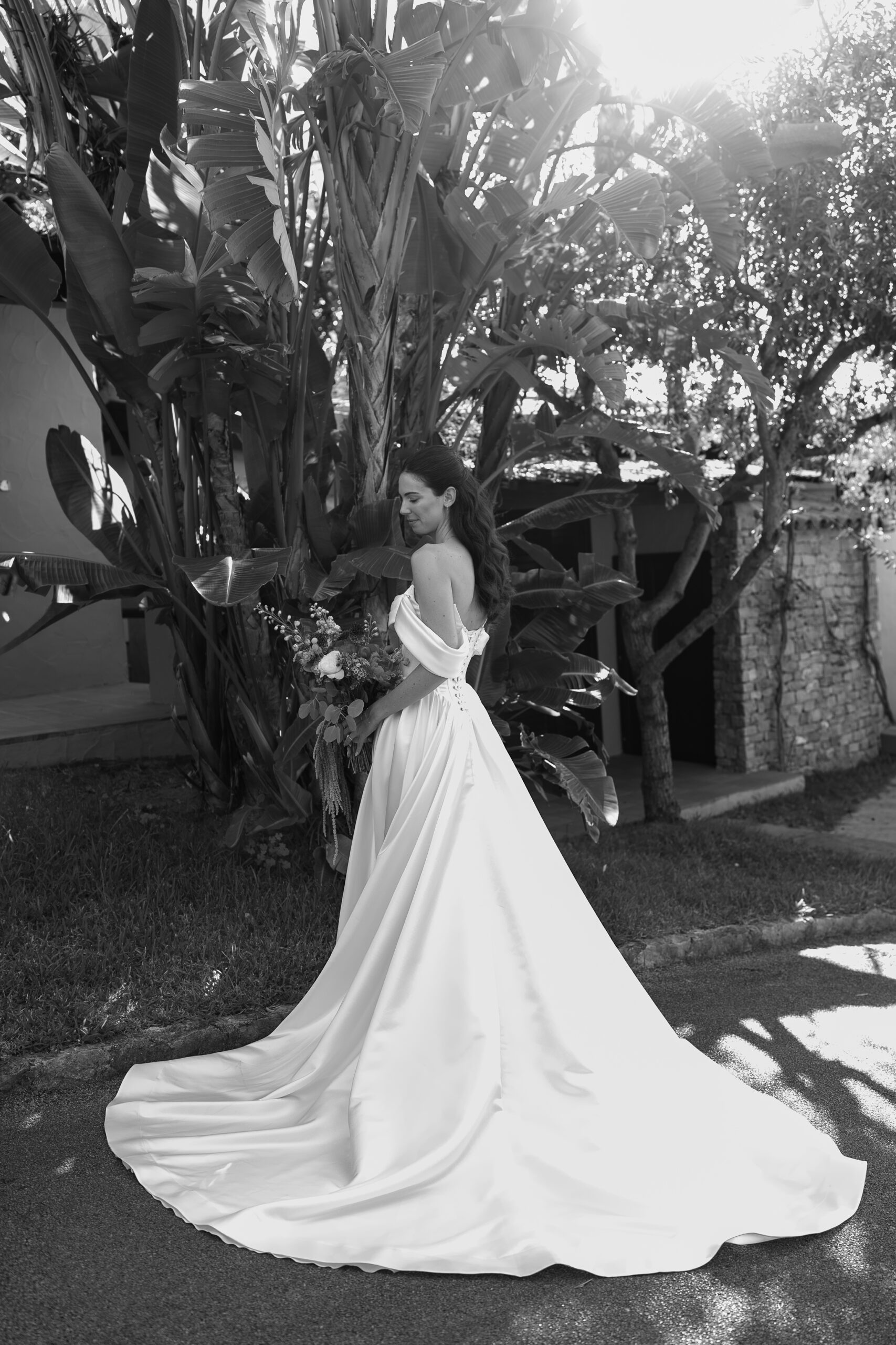 Morane walking beneath the trees in her wedding dress