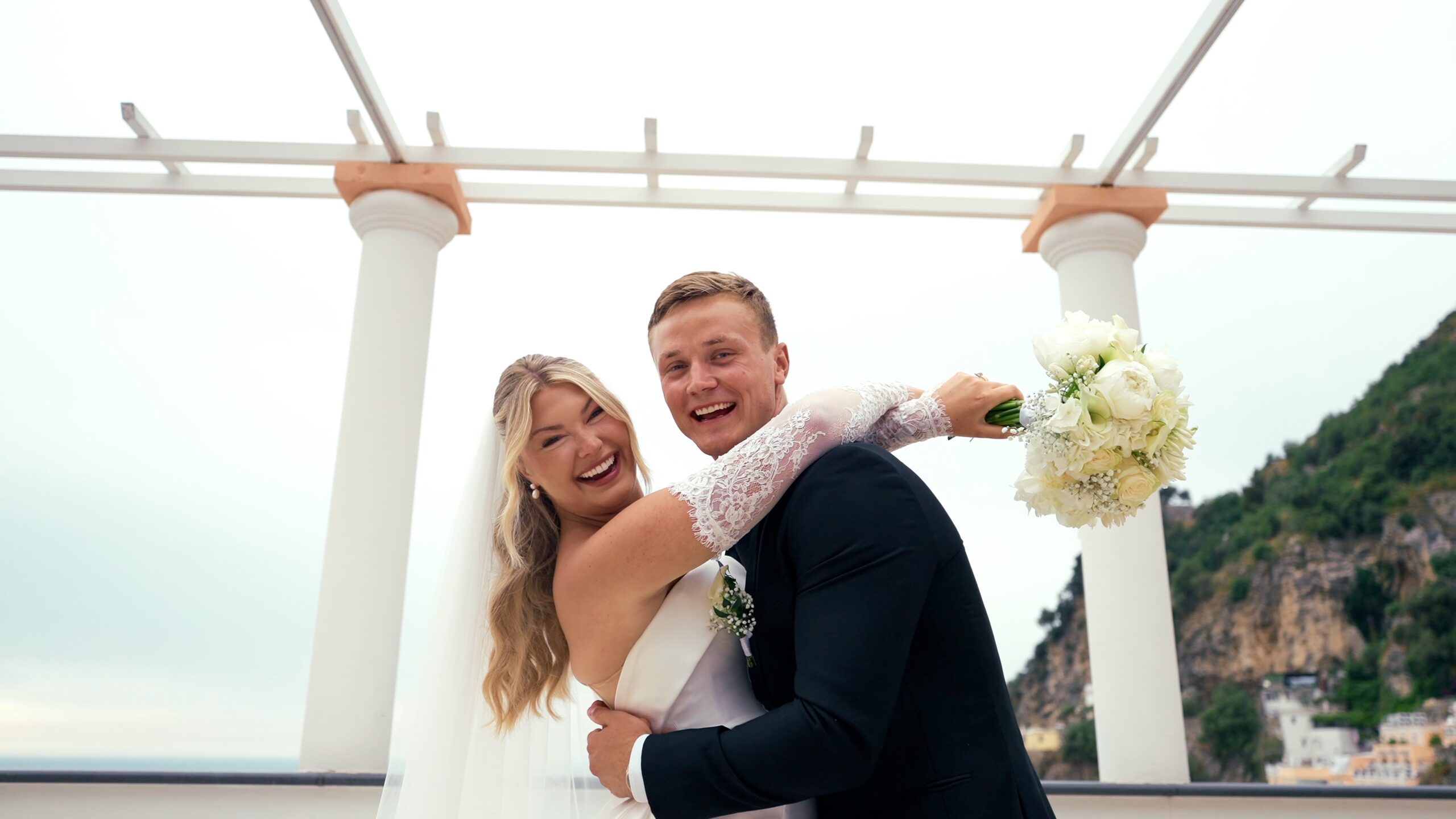 Groom lifting the bride during an Italian destination wedding