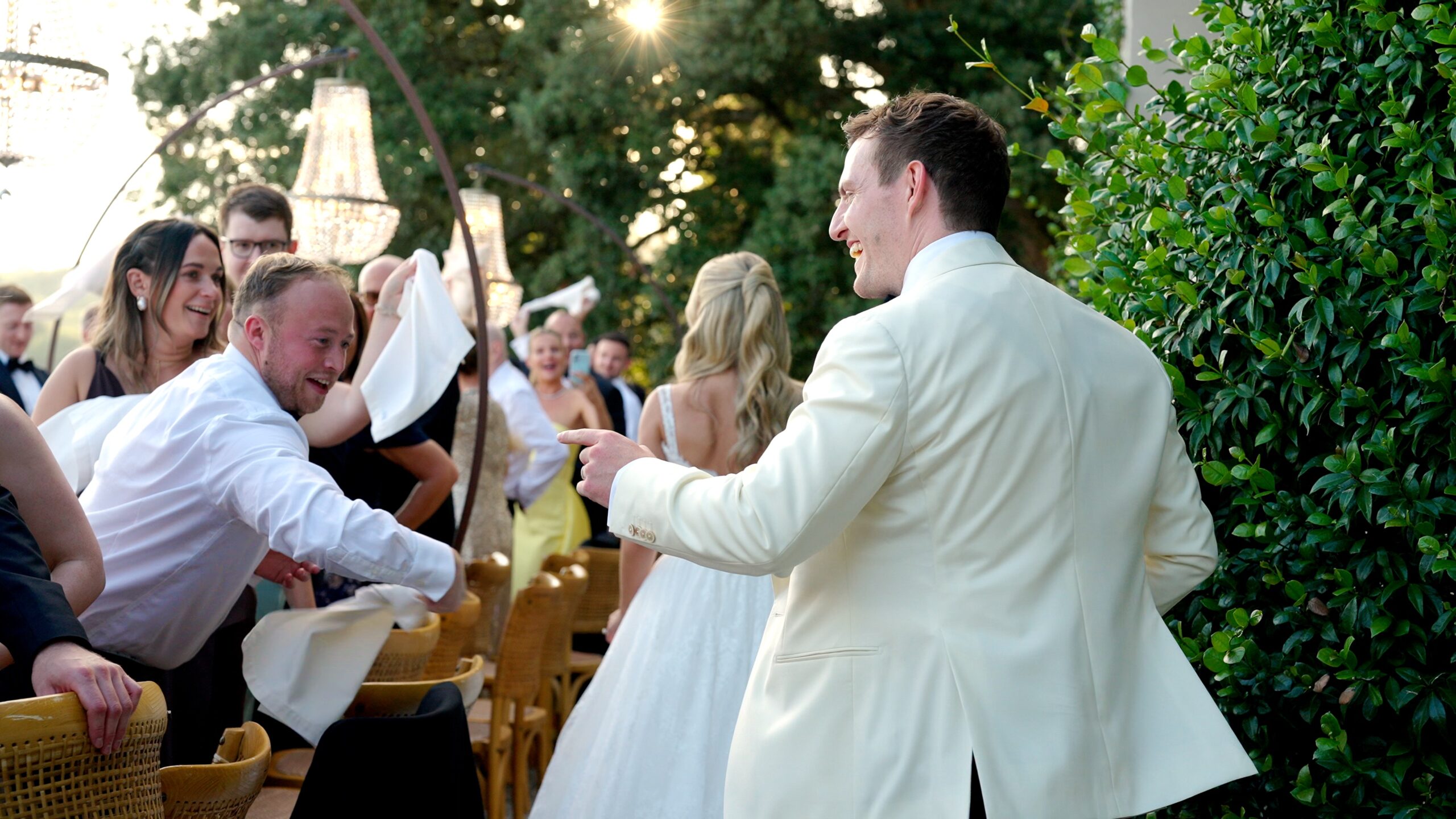 Chloe and Mike celebrating with their guests during an outdoor wedding reception at Villa Fabbriche Palma.
