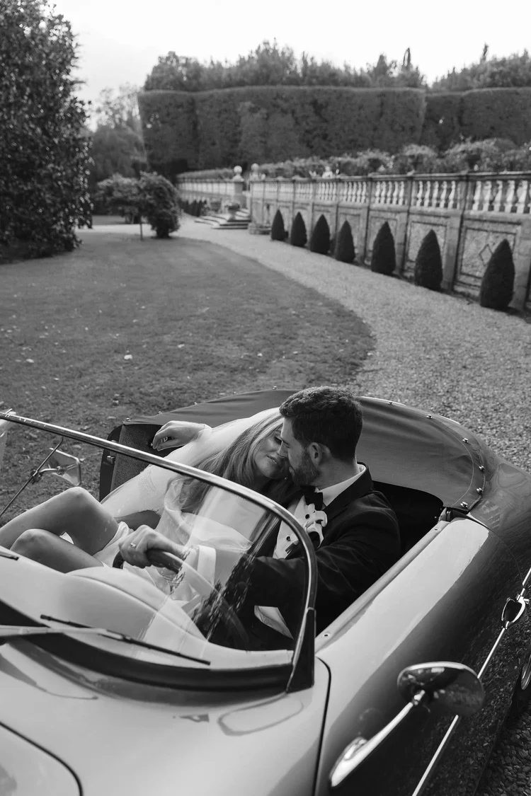 Adam and Bex in a vintage car at their Villa Grabau wedding in Tuscany