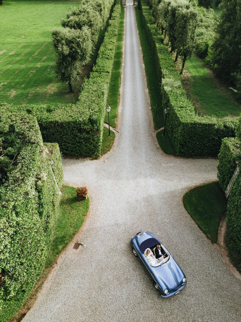 Bride arriving in a vintage car at Villa Grabau in Tuscany