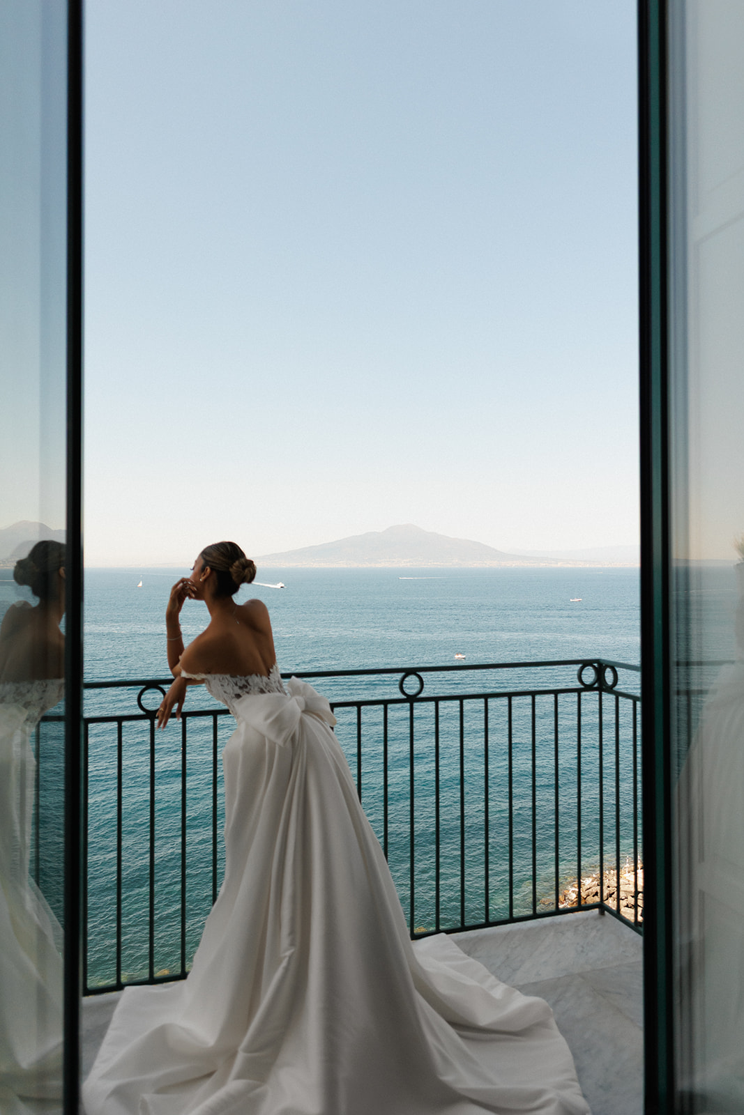 Bride overlooking the Mediterranean from a balcony at Bellevue Syrene in Sorrento