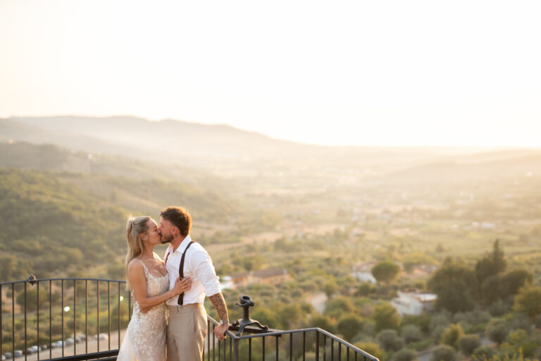 Adam and Polly kissing at sunset on the Domus Laeta terrace