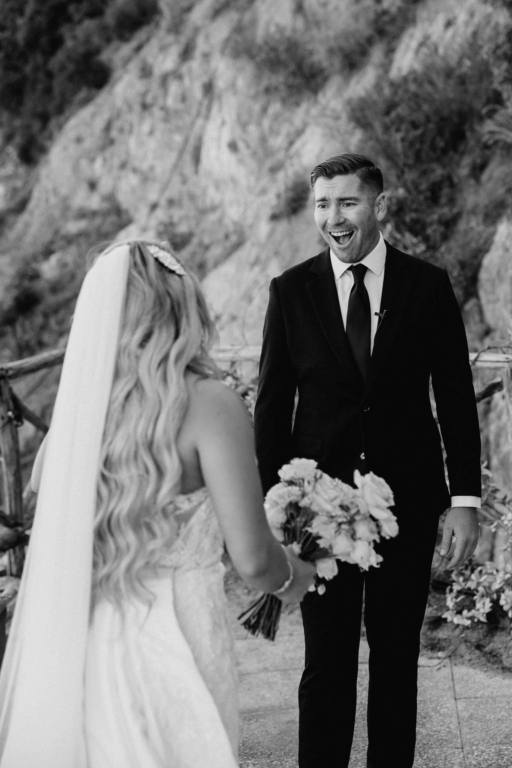 Black and white portrait of the bride and groom walking together