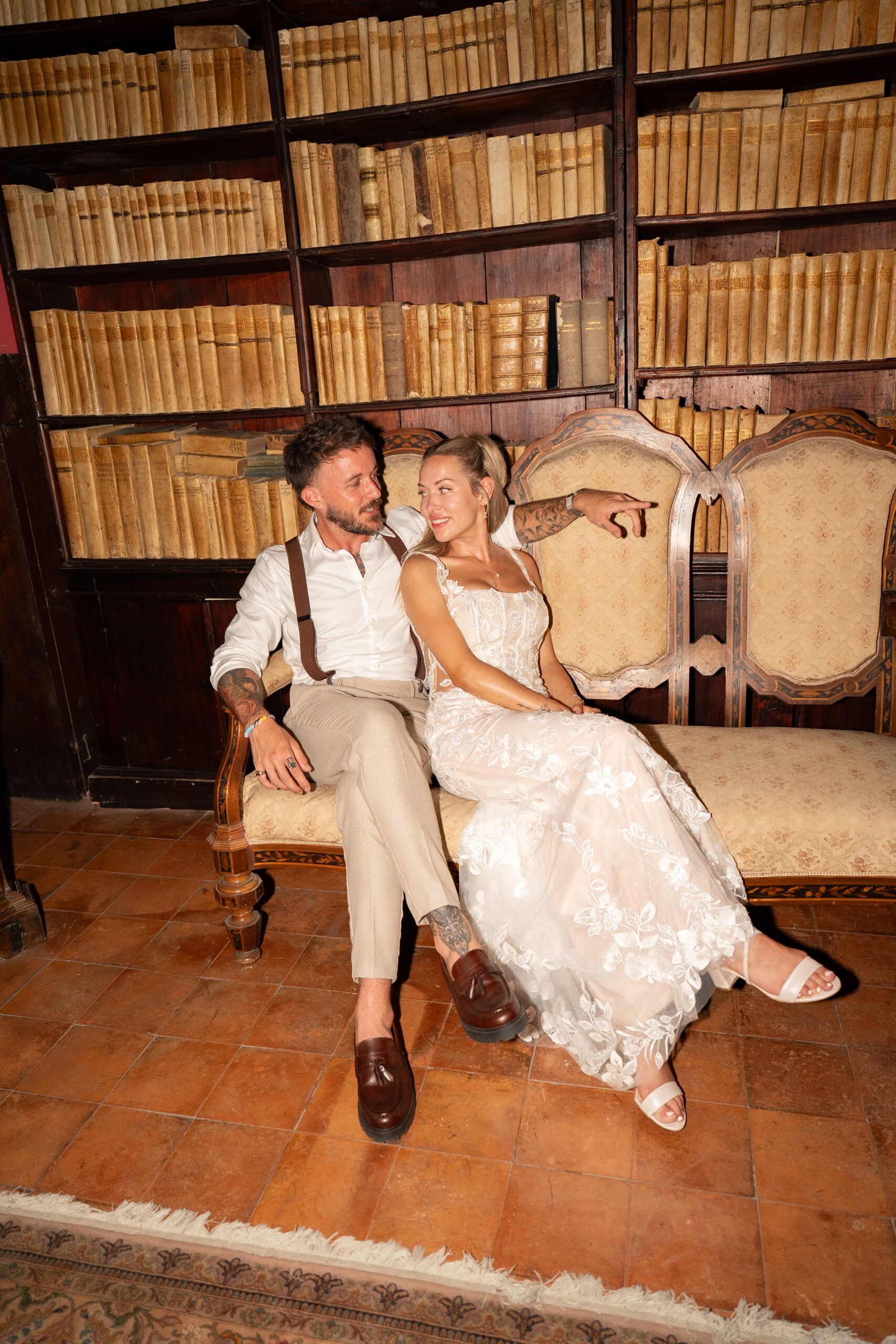 Adam and Polly laughing together in the historic Domus Laeta library