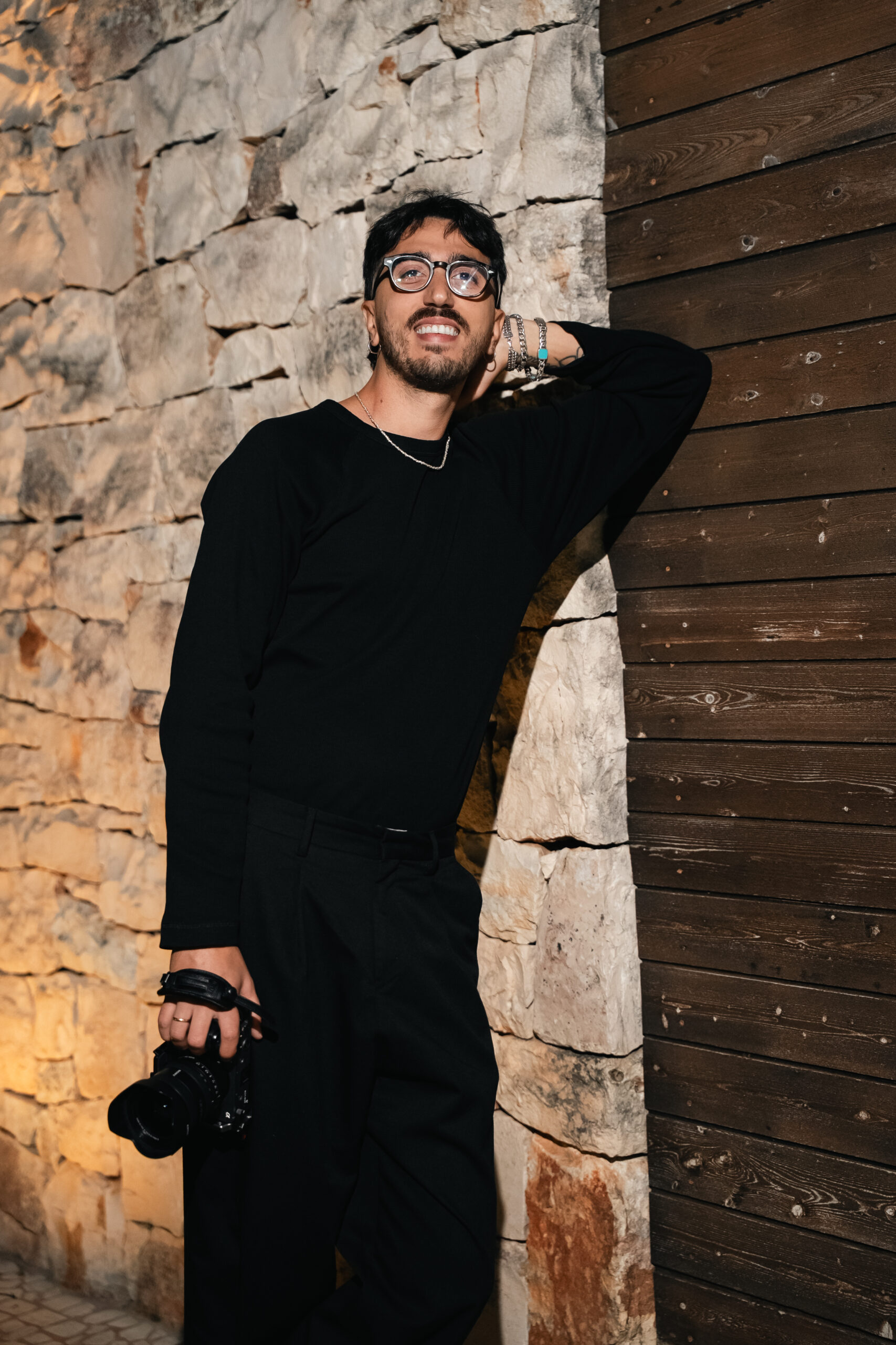 Luigi Rainone, Italian destination wedding filmmaker, holding his camera