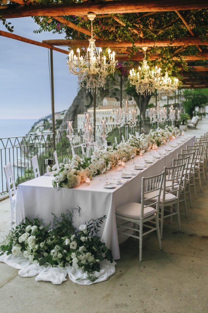 Elegant wedding dinner table overlooking the sea at Anantara Convento di Amalfi